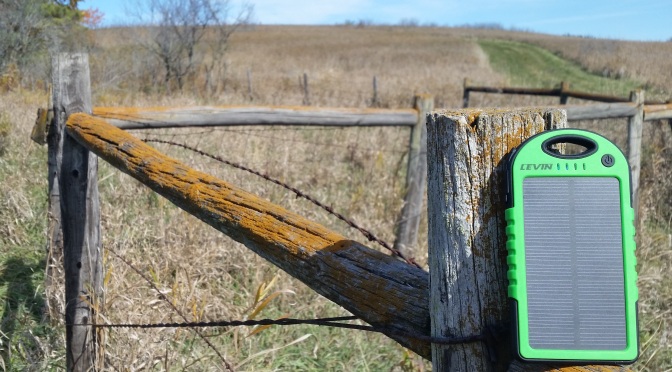 LEVIN Solstar solar charging on fence post overlooking a nature prairie in Minnesota.